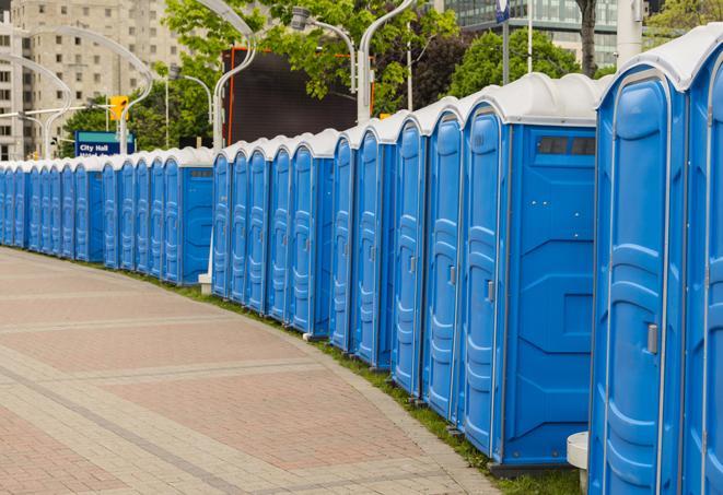 a row of portable restrooms at an outdoor special event, ready for use in Youngwood, PA